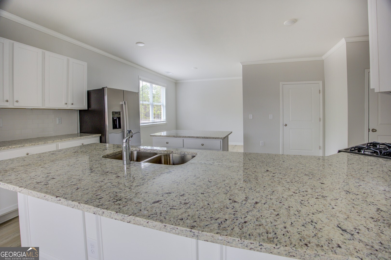 1007 Towne Circle Social Circle, GA 30025 - Photo 23 of 48 a kitchen with a granite countertop sink and cabinets