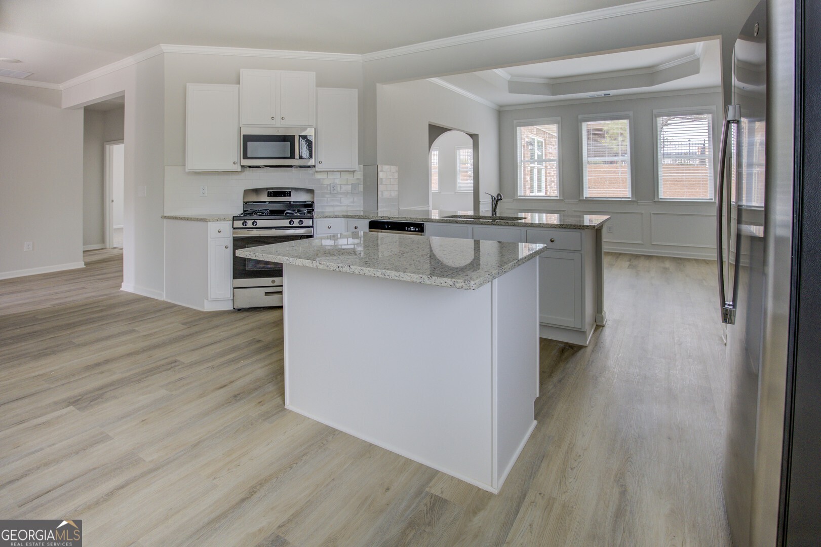 1007 Towne Circle Social Circle, GA 30025 - Photo 25 of 48 a kitchen with stainless steel appliances granite countertop a sink stove and refrigerator