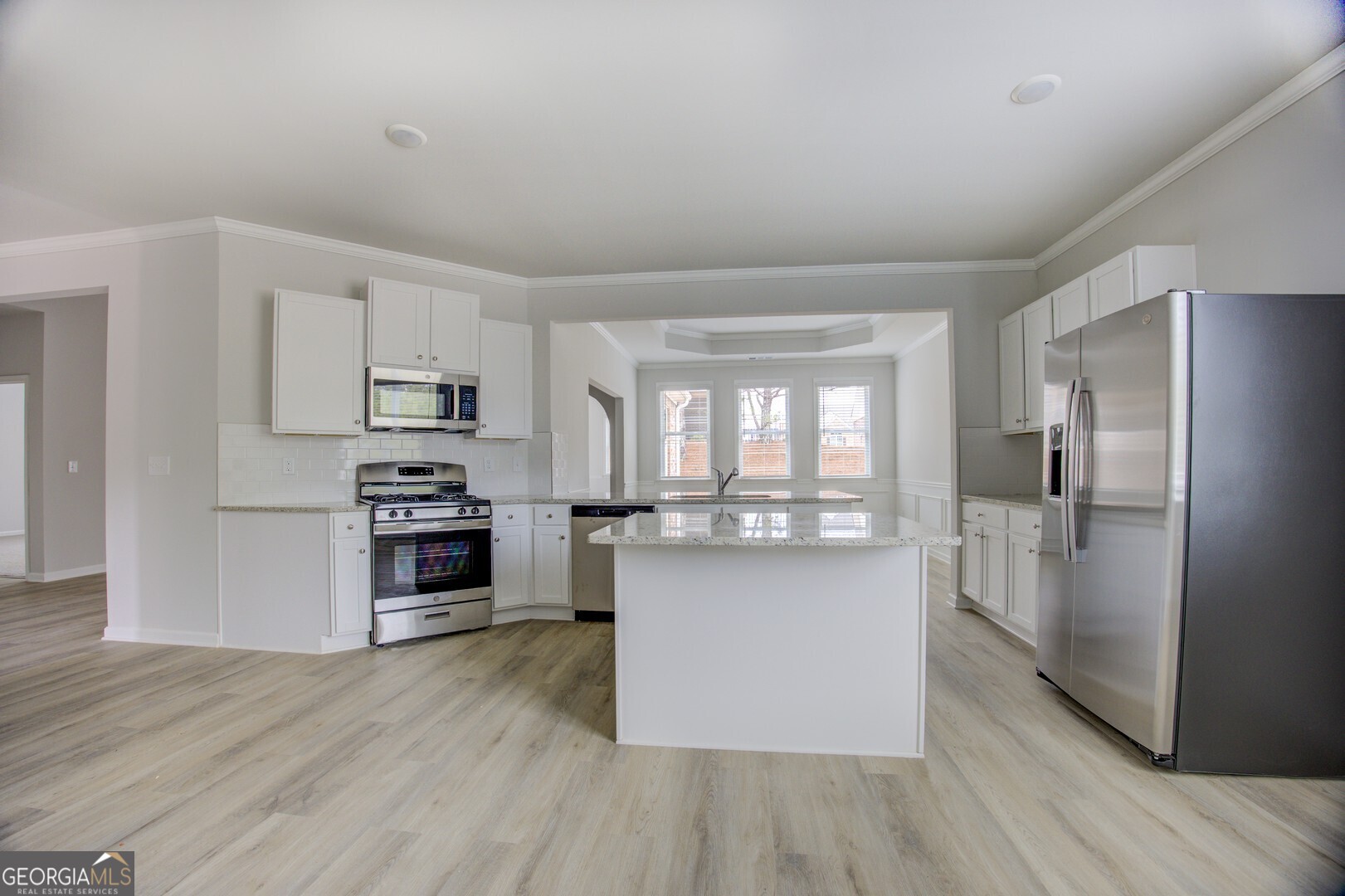 1007 Towne Circle Social Circle, GA 30025 - Photo 31 of 48 a kitchen with stainless steel appliances a refrigerator and a stove top oven