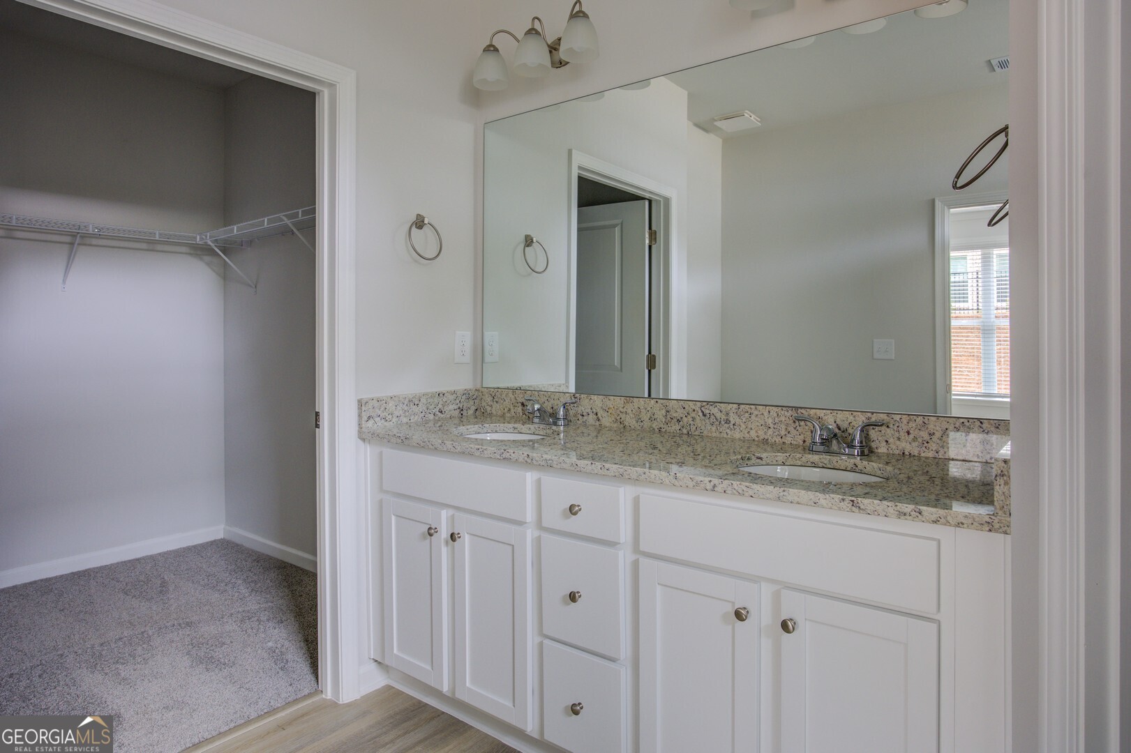 1007 Towne Circle Social Circle, GA 30025 - Photo 37 of 48 a bathroom with a granite countertop sink and a mirror