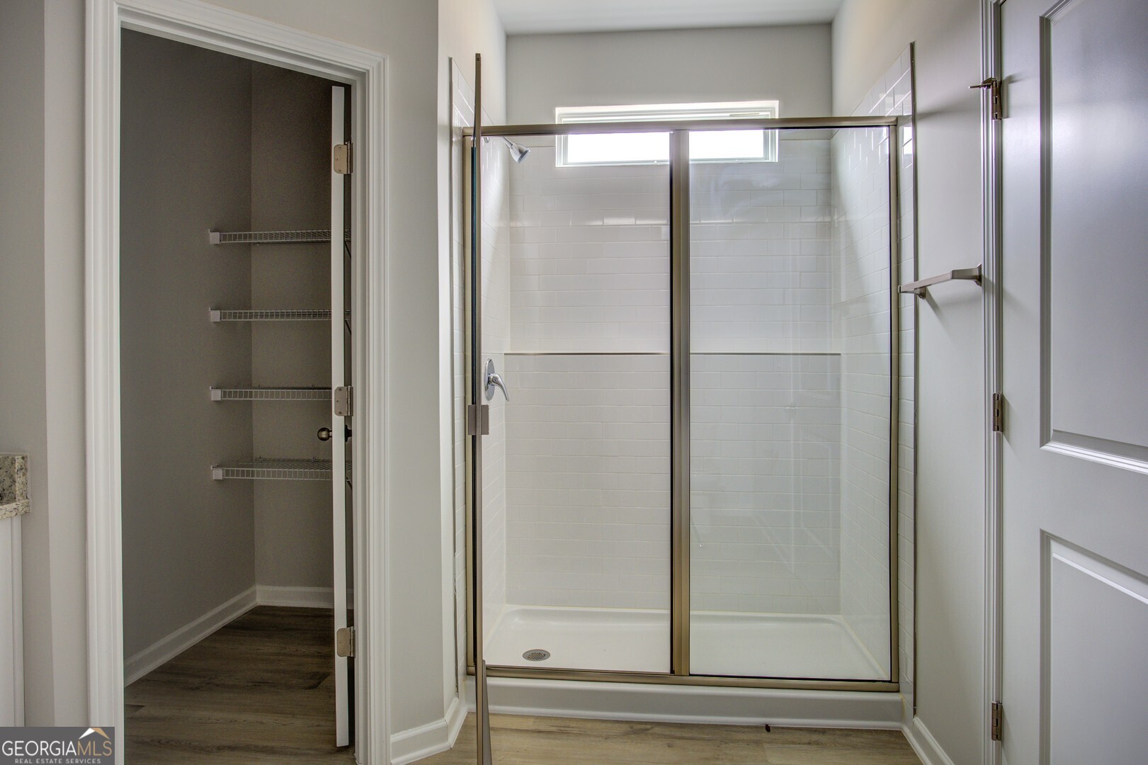 1007 Towne Circle Social Circle, GA 30025 - Photo 38 of 48 a bathroom with a glass shower door