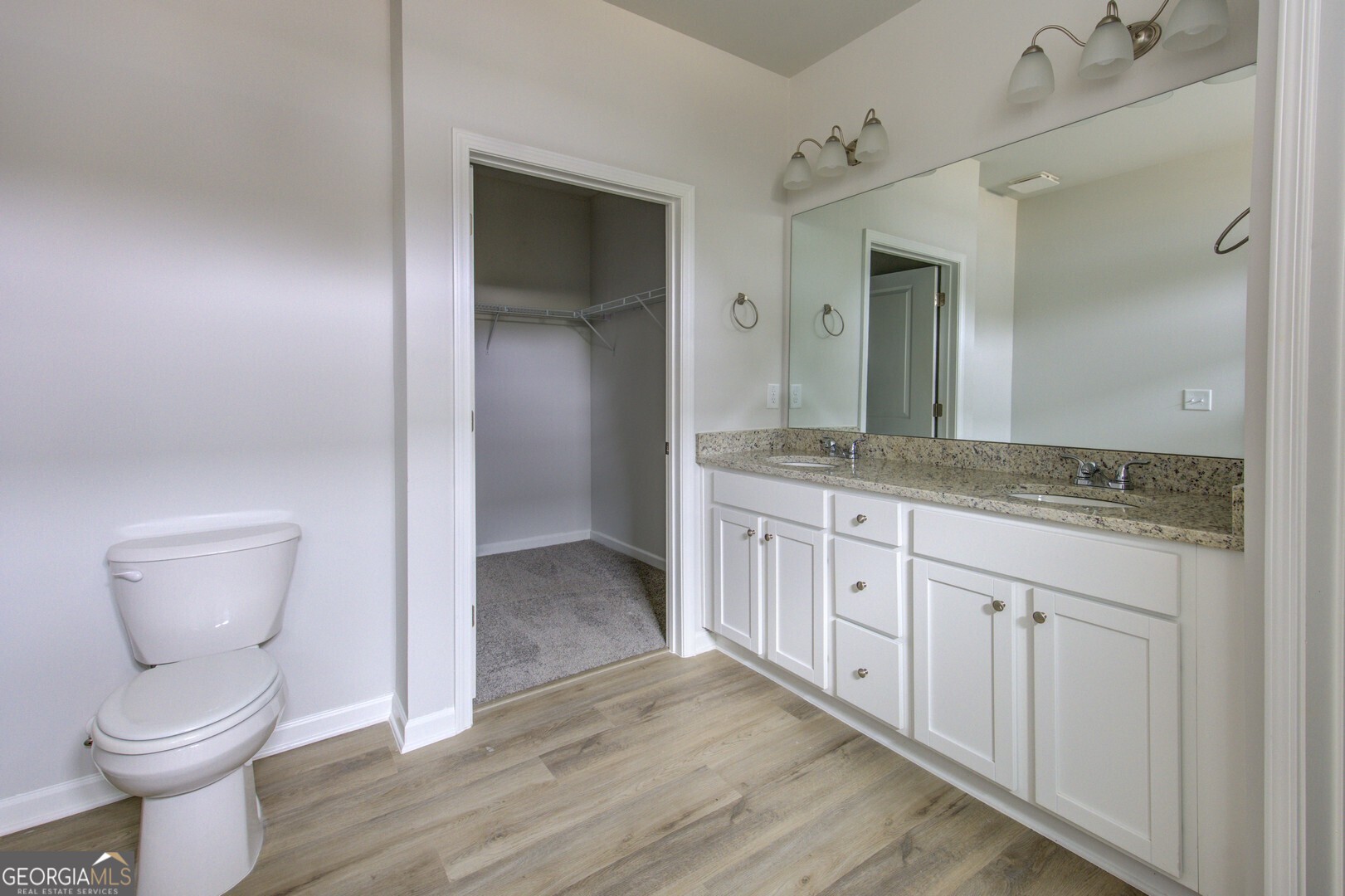 1007 Towne Circle Social Circle, GA 30025 - Photo 39 of 48 a spacious bathroom with a granite countertop toilet sink and mirror