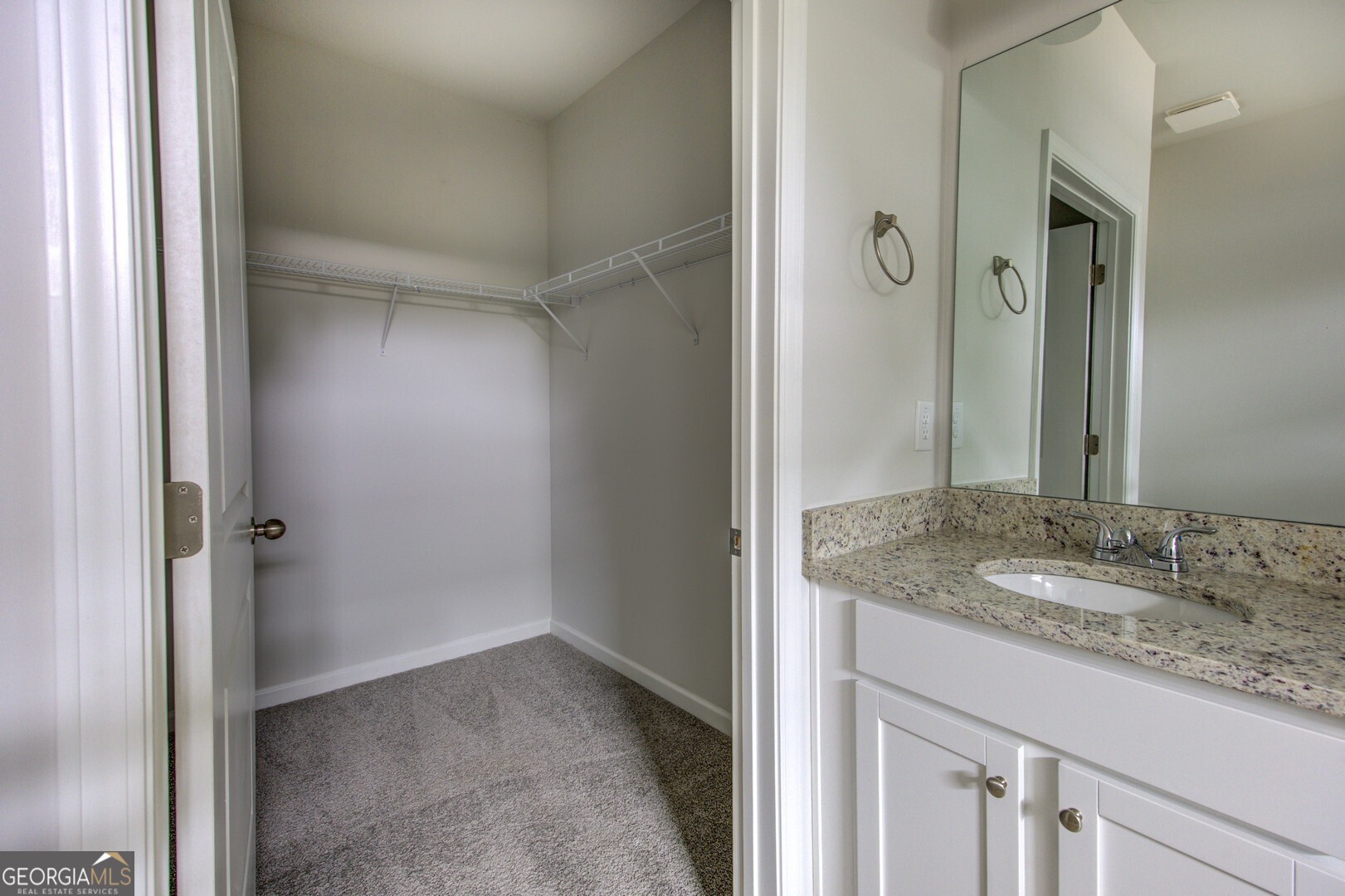 1007 Towne Circle Social Circle, GA 30025 - Photo 40 of 48 a bathroom with a granite countertop sink and a mirror