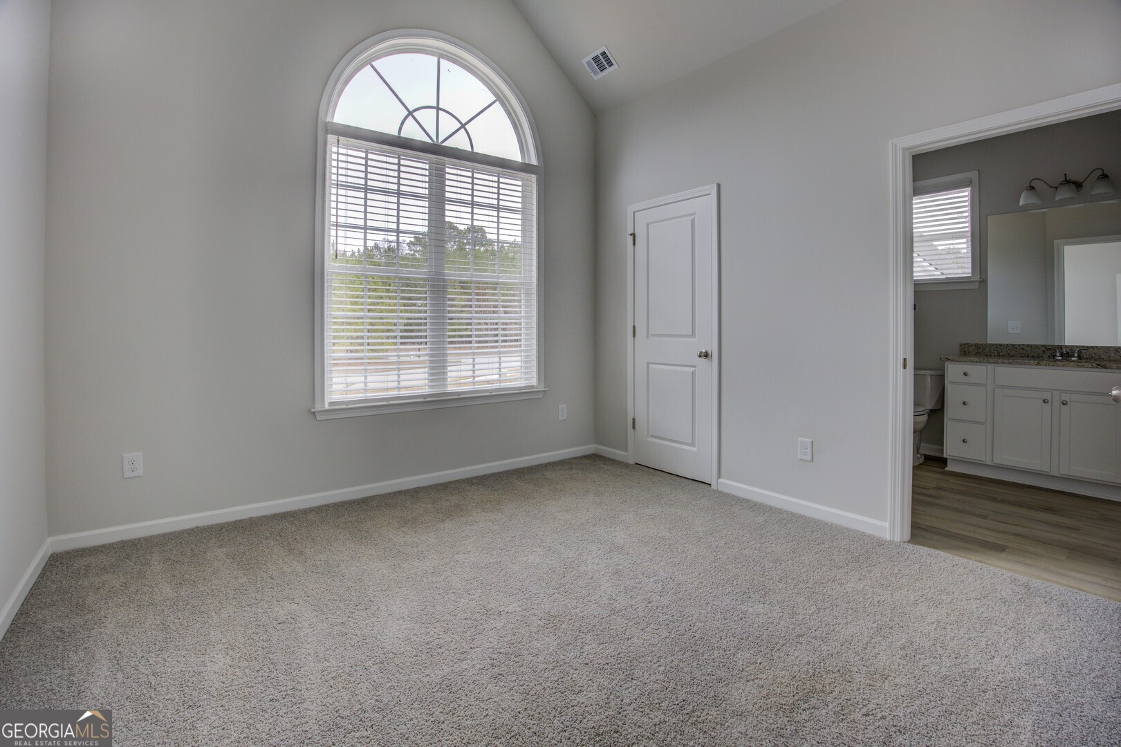 1007 Towne Circle Social Circle, GA 30025 - Photo 41 of 48 an empty room with a fireplace and windows