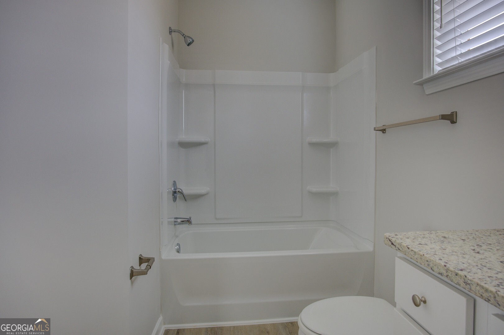 1007 Towne Circle Social Circle, GA 30025 - Photo 45 of 48 a bathroom with a granite countertop toilet tub and sink