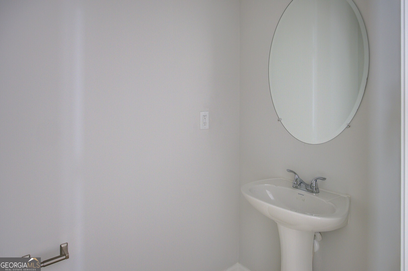 1007 Towne Circle Social Circle, GA 30025 - Photo 47 of 48 a bathroom with a sink and a mirror