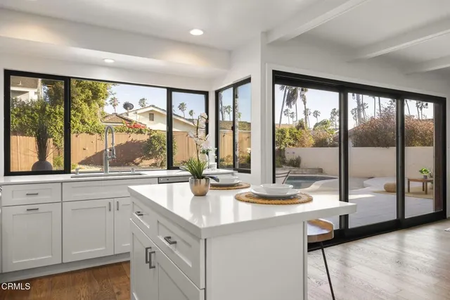 a kitchen with sink and large window