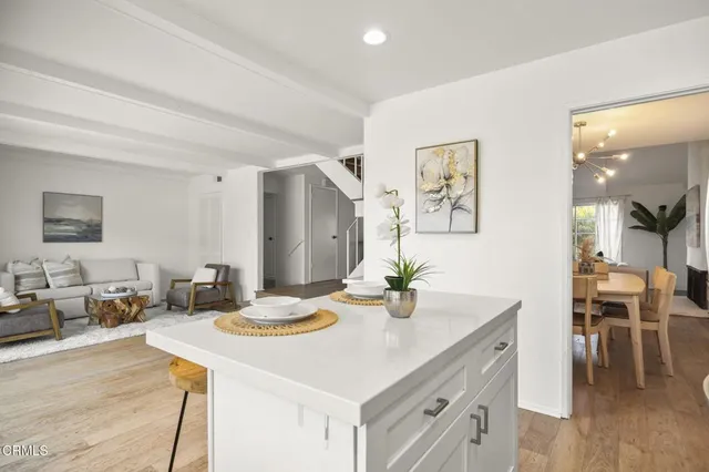 a kitchen with a sink cabinets and wooden floor