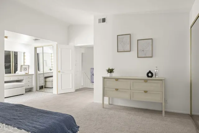 a bedroom with a bed and a desk