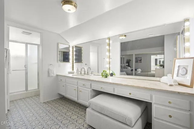 a spacious bathroom with a granite countertop sink and a mirror