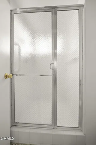 a bathroom with a glass shower door