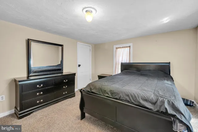 a bedroom with a bed and a dresser