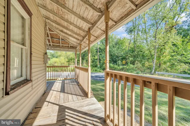 a view of balcony with wooden floor and fence