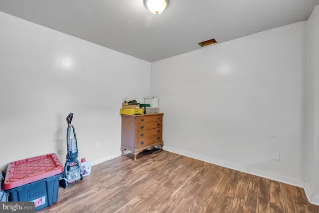 a view of room with wooden floor