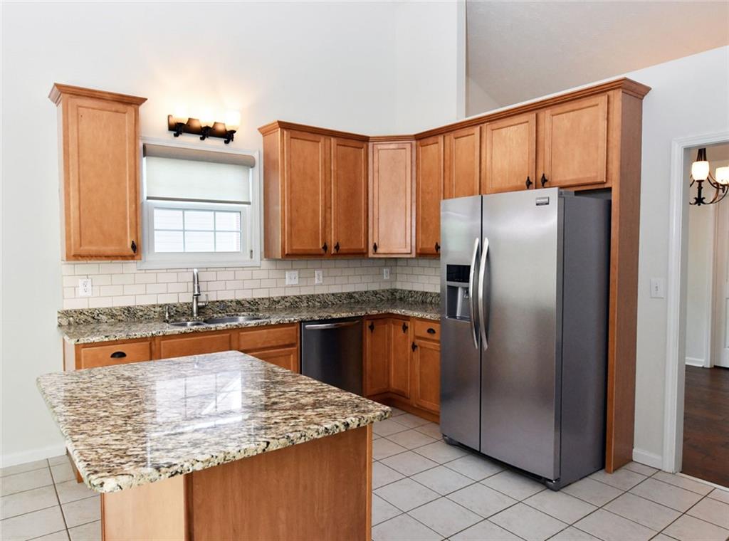 795 Sunset Ridge Lane Southeast Lawrenceville, GA 30045 - Photo 11 of 57 a kitchen with stainless steel appliances granite countertop a refrigerator and a sink