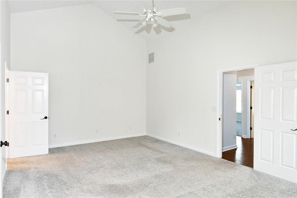 795 Sunset Ridge Lane Southeast Lawrenceville, GA 30045 - Photo 16 of 57 an empty room with a ceiling fan and a window