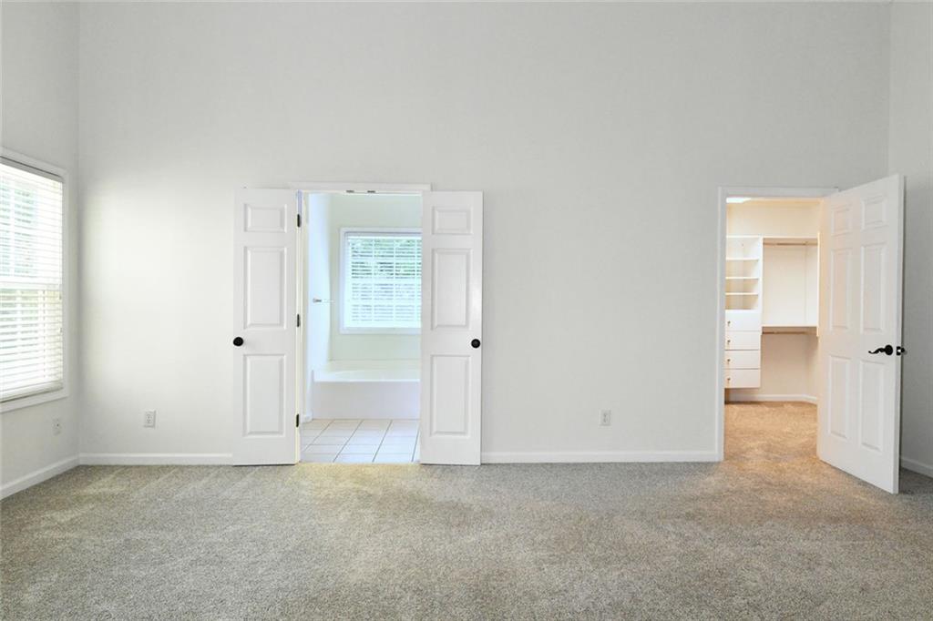 795 Sunset Ridge Lane Southeast Lawrenceville, GA 30045 - Photo 17 of 57 an empty room with windows and closet