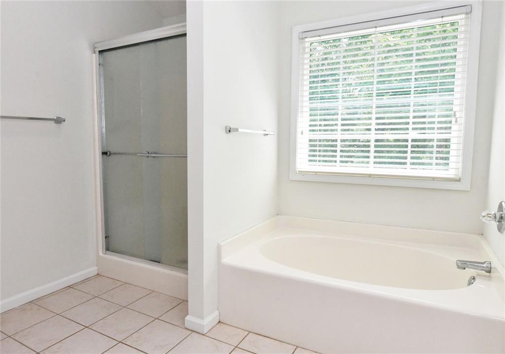 795 Sunset Ridge Lane Southeast Lawrenceville, GA 30045 - Photo 19 of 57 a white bath tub sitting next to a window