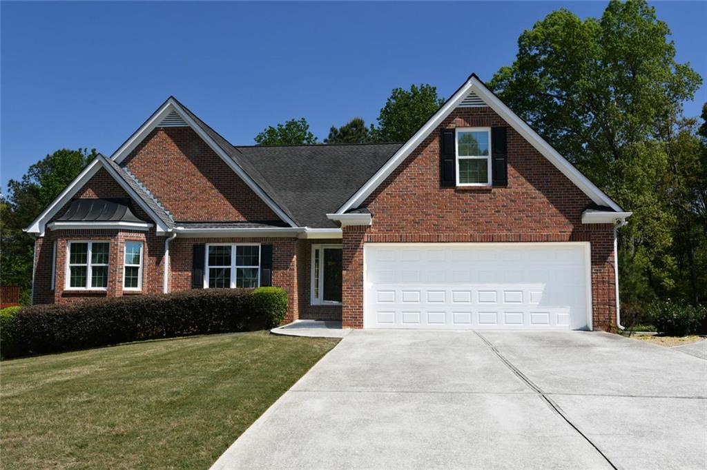 795 Sunset Ridge Lane Southeast Lawrenceville, GA 30045 - Photo 2 of 57 a front view of a house with a yard and garage