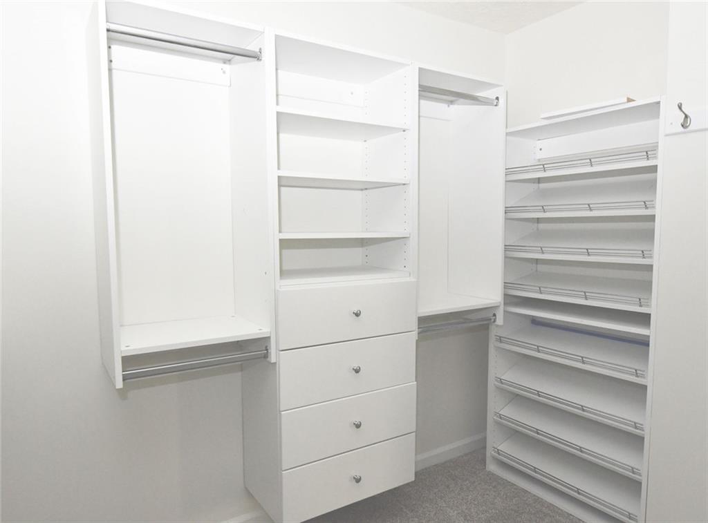 795 Sunset Ridge Lane Southeast Lawrenceville, GA 30045 - Photo 21 of 57 a view of walk in closet with empty racks