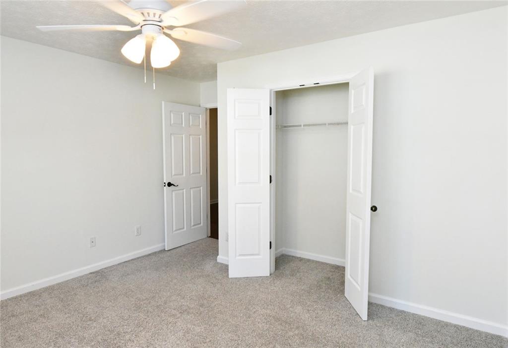 795 Sunset Ridge Lane Southeast Lawrenceville, GA 30045 - Photo 22 of 57 an empty room with a fan and a fan