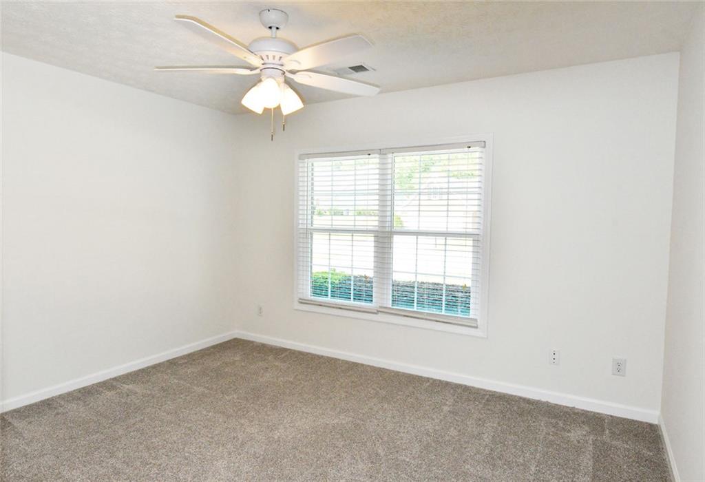 795 Sunset Ridge Lane Southeast Lawrenceville, GA 30045 - Photo 25 of 57 an empty room with a window and a fan