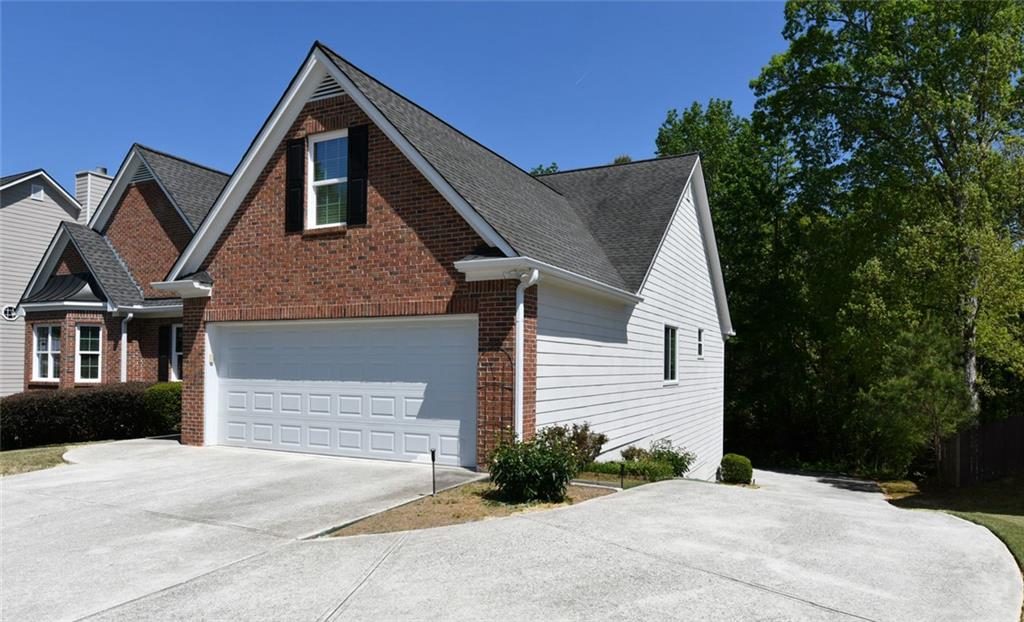 795 Sunset Ridge Lane Southeast Lawrenceville, GA 30045 - Photo 3 of 57 a front view of a house with a yard and garage