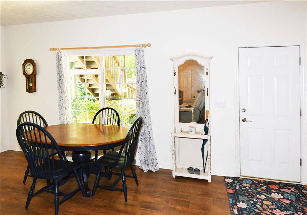 795 Sunset Ridge Lane Southeast Lawrenceville, GA 30045 - Photo 34 of 57 a dining room with furniture and wooden floor