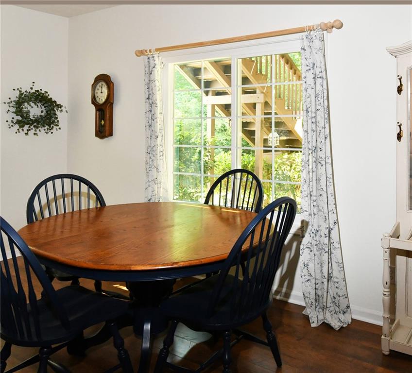 795 Sunset Ridge Lane Southeast Lawrenceville, GA 30045 - Photo 35 of 57 a view of a dining room with furniture and wooden floor