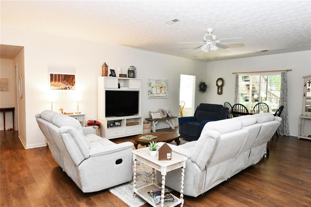 795 Sunset Ridge Lane Southeast Lawrenceville, GA 30045 - Photo 36 of 57 a living room with furniture and a flat screen tv