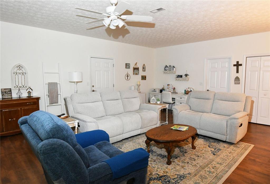 795 Sunset Ridge Lane Southeast Lawrenceville, GA 30045 - Photo 38 of 57 a living room with furniture a rug and a chandelier