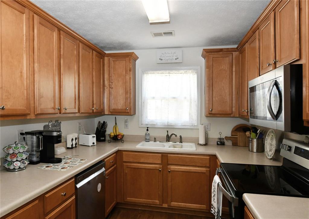 795 Sunset Ridge Lane Southeast Lawrenceville, GA 30045 - Photo 40 of 57 a kitchen with a sink cabinets and window