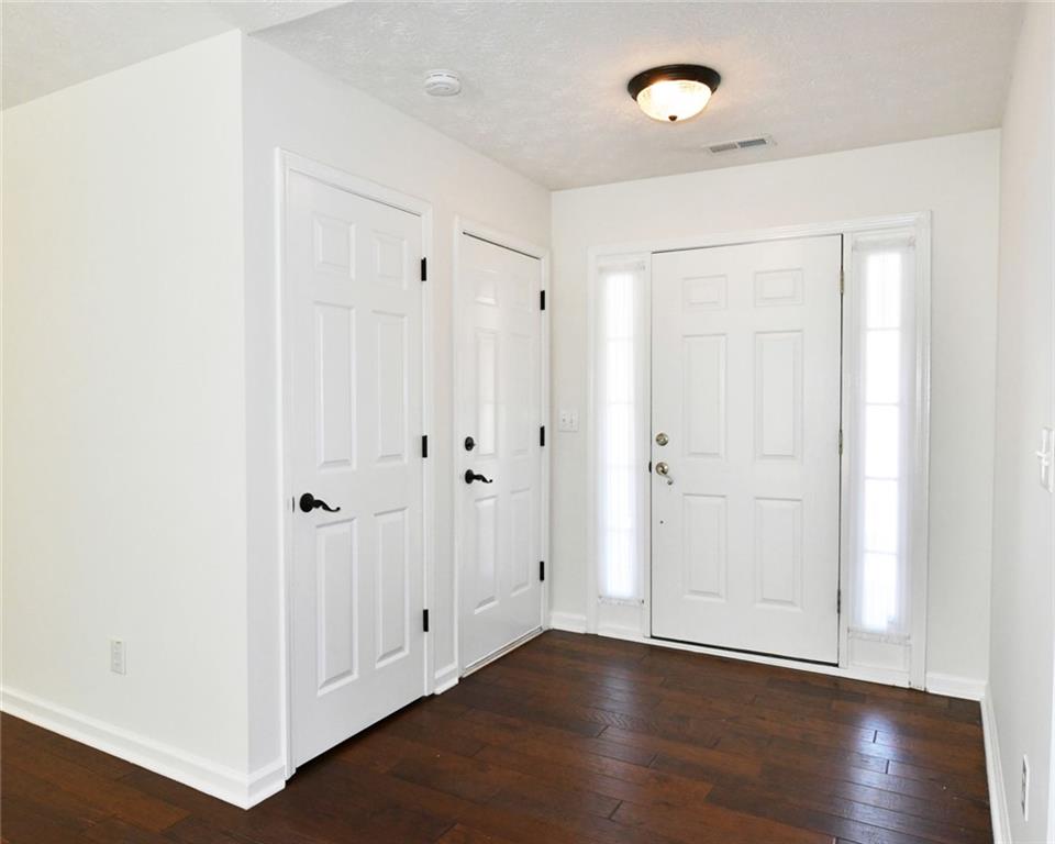 795 Sunset Ridge Lane Southeast Lawrenceville, GA 30045 - Photo 4 of 57 a view of an empty room with wooden floor