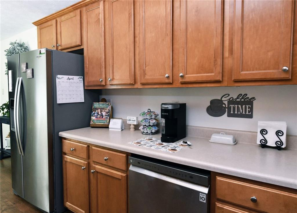 795 Sunset Ridge Lane Southeast Lawrenceville, GA 30045 - Photo 41 of 57 a kitchen with stainless steel appliances granite countertop a refrigerator a sink and dishwasher with cabinets