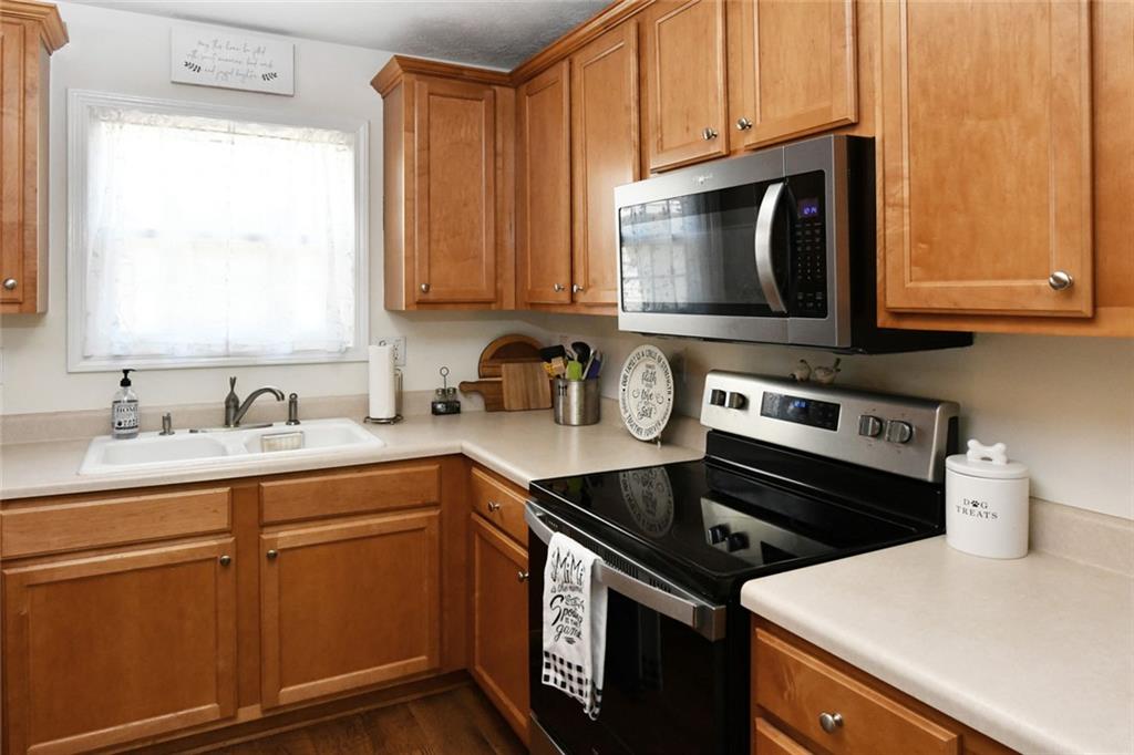 795 Sunset Ridge Lane Southeast Lawrenceville, GA 30045 - Photo 42 of 57 a kitchen with a stove and a microwave