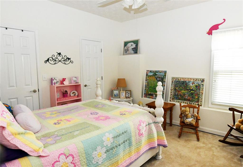 795 Sunset Ridge Lane Southeast Lawrenceville, GA 30045 - Photo 46 of 57 a bedroom with a bed and a table