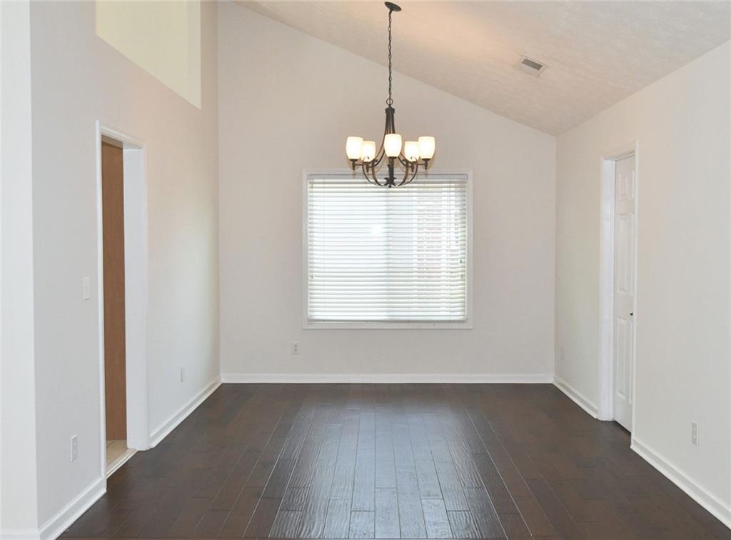 795 Sunset Ridge Lane Southeast Lawrenceville, GA 30045 - Photo 10 of 57 a view of a room with wooden floor closet and a window