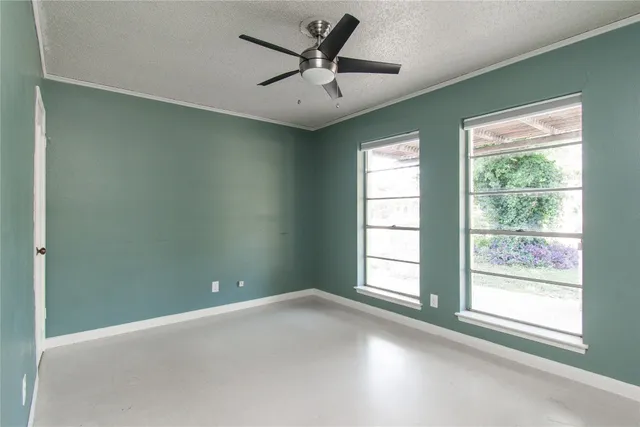 a view of a livingroom with a ceiling fan and window