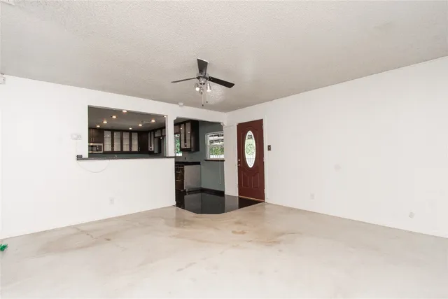 a view of a kitchen with a sink and a refrigerator