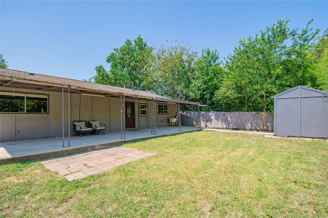 a backyard of a house with table and chairs