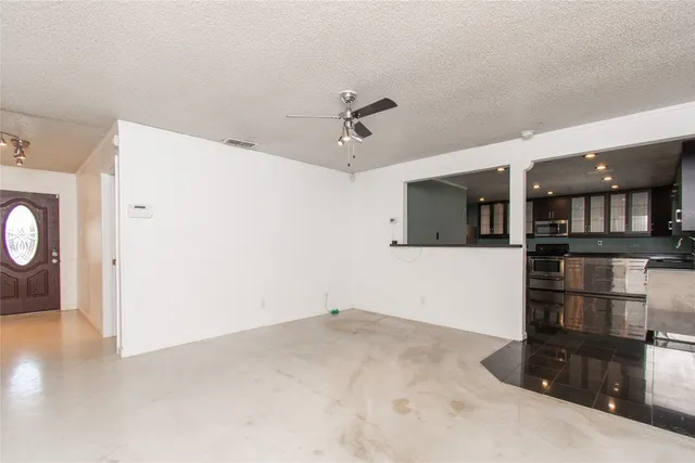 a view of a kitchen with a sink and a refrigerator