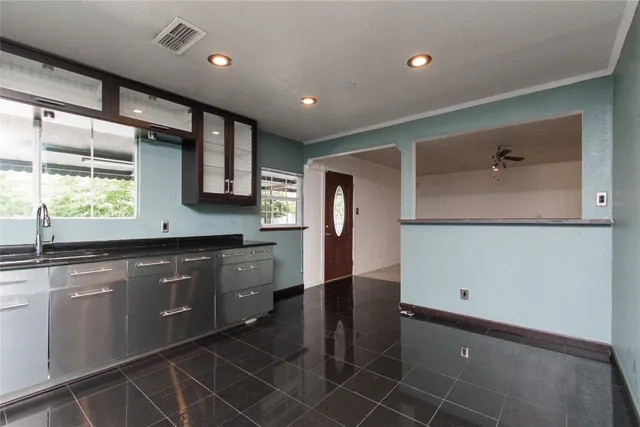 a large kitchen with kitchen island a sink stainless steel appliances and cabinets