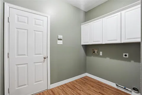 a view of cabinets and wooden floor