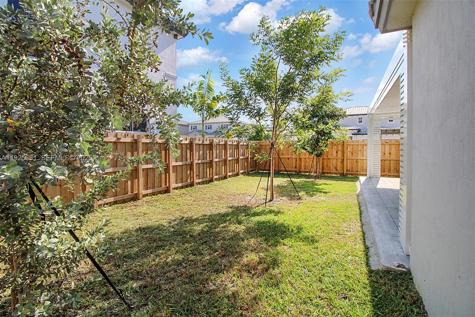 879 Southeast 26th Terrace Homestead, FL 33035 - Photo 10 of 43 a view of a yard with basketball court