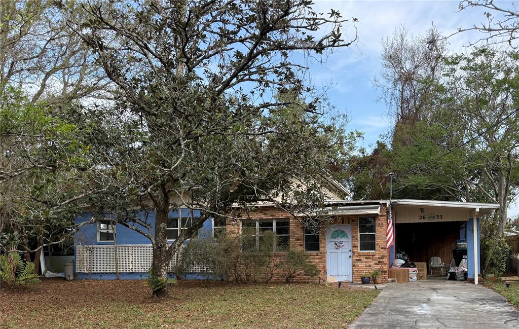 2633 East Compton Street Orlando, FL 32806 - Photo 1 of 1 a view of a house with backyard and trees