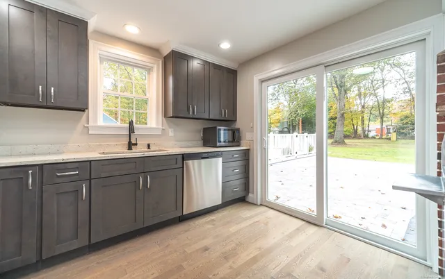 a kitchen with stainless steel appliances granite countertop a stove and a refrigerator