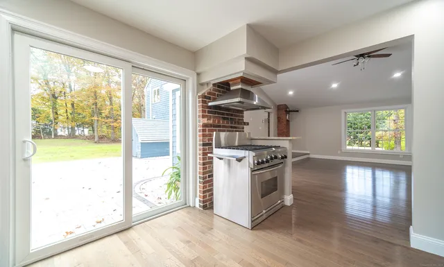 a kitchen with kitchen island granite countertop wooden cabinets and refrigerator