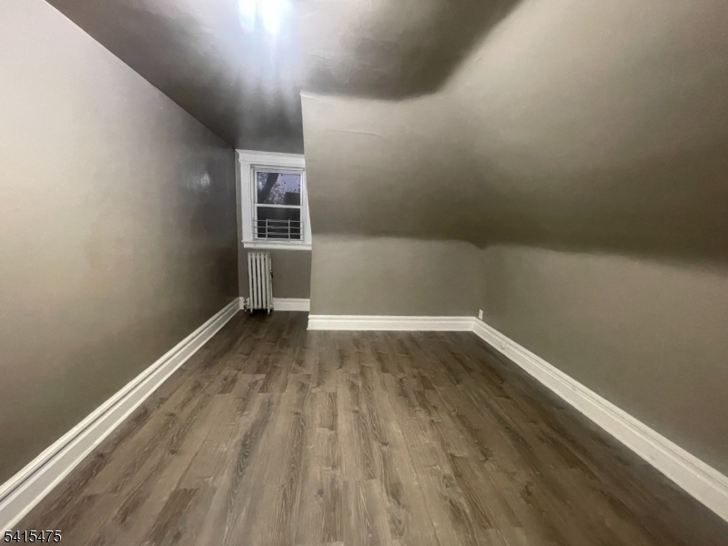 43 Mapes Avenue, Unit 2L Newark, NJ 07112 - Photo 7 of 7 a view of a room with wooden floor and white walls