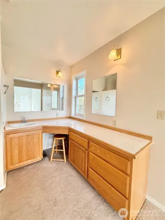 a bathroom with a sink toilet and mirror