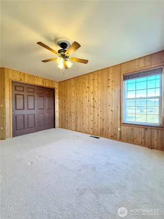 a view of a livingroom with a ceiling fan and window